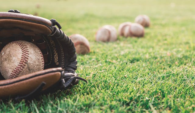 a%20baseball%20in%20a%20glove%20with%20other%20baseballs%20in%20the%20background a%20baseball%20in%20a%20glove%20with%20other%20baseballs%20in%20the%20background